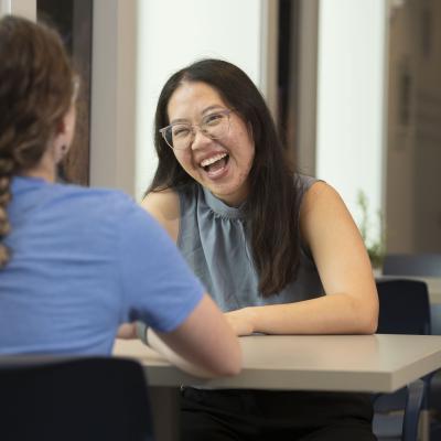 Admissions counselor at a table with a student 